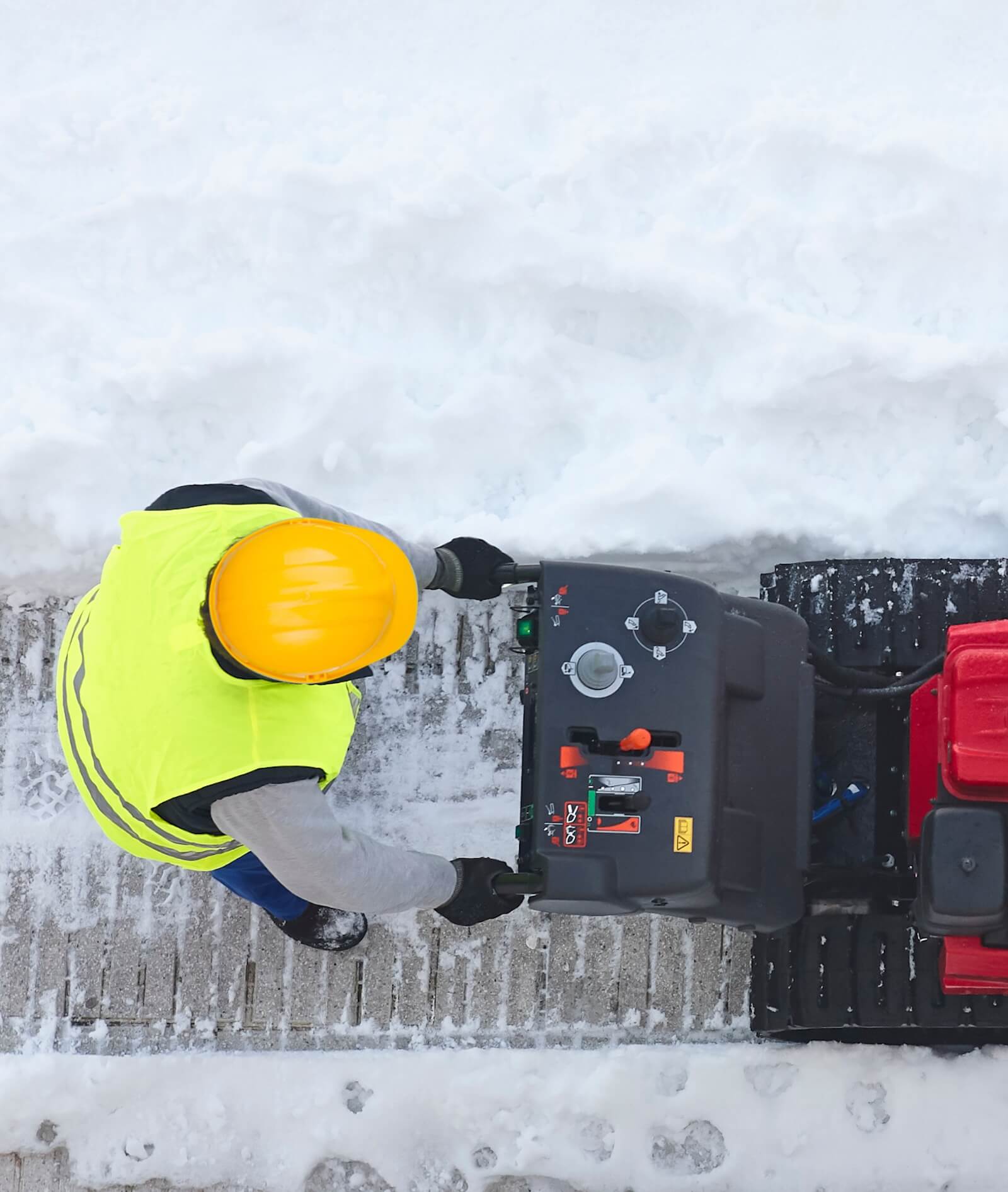 Snow plow clearing a residential driveway in Edmonton