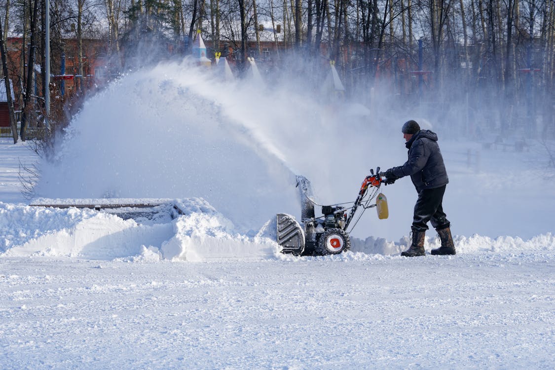 Snow removal service in Edmonton clearing snow near a home